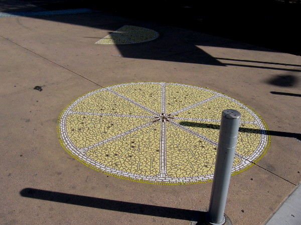 A walkway between the Celsius residential building and the Lemon Grove Trolley Depot contains tile mosaic lemon slices!