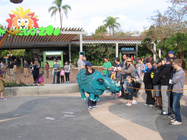 A fun blue rhino circles around the sculpture to the delight of young and old alike!