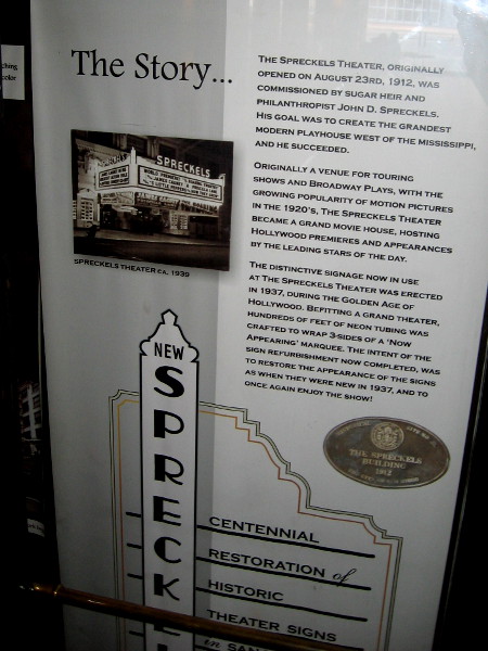 A sign describes the Spreckels Theatre story. In the 1920's, it was transformed into a grand movie house, hosting Hollywood premieres and the leading stars of the day.