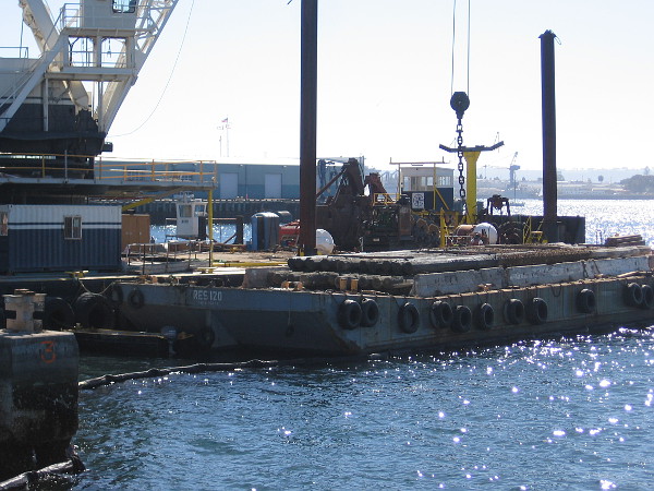 Many extracted piles were already stacked on the barge beside the crane when I walked by.
