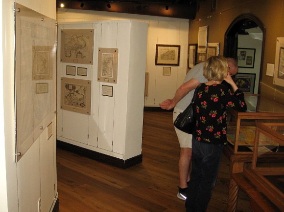 Visitors look at an amazing collection of historic maps at the Map and Atlas Museum of La Jolla.