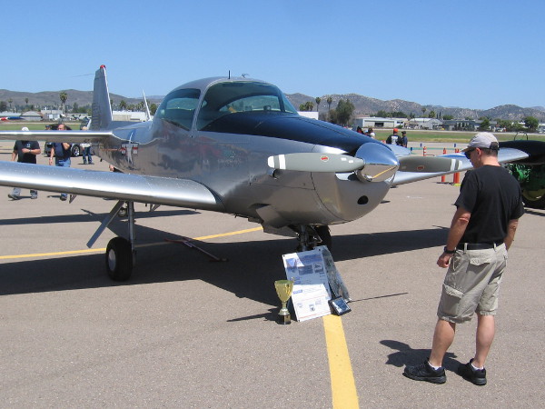 Someone looks at a restored North American L-17 aircraft on display at Gillespie Field during a special Air Group One event.