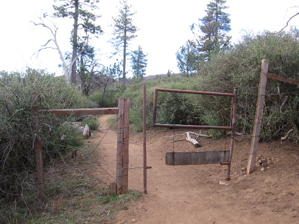 A swinging gate on the trail. Sometimes cattle are herded up in these mountains.