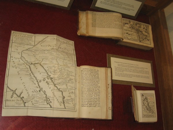 A display case at the Map and Atlas Museum of La Jolla includes geographic playing cards from the early 18th century.