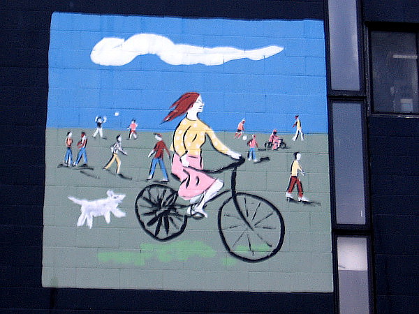 Riding a bicycle with a dog in the active city.