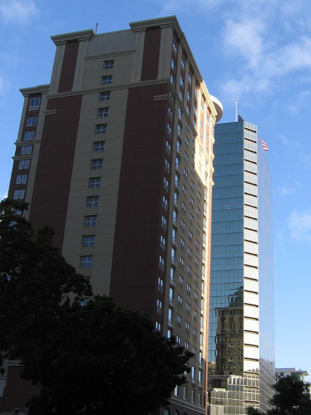 Buildings to the north catch early morning light.
