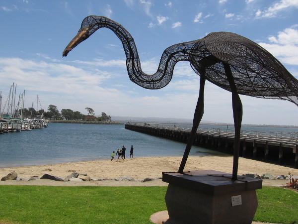 A family enjoys the small beach near the fishing pier at the south end of Bayside Park.