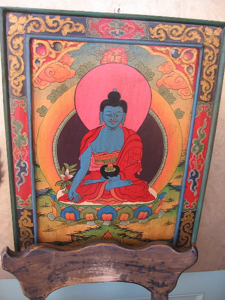 Blue Buddha among flowers outside the entrance to Gum Saan.