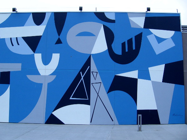 Right half of mural by Rafael Lopez outside Coasterra on Harbor Island seems to depict a lady enjoying food and drink.