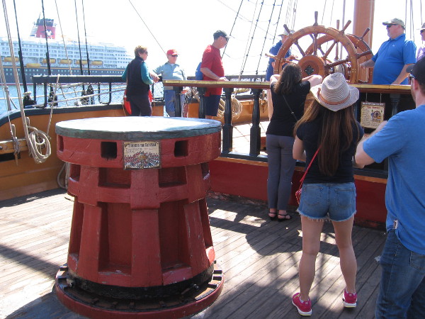 The Disney Wonder cruise ship is seen beyond the capstan. HMS Surprise was used in the filming of the movie Pirates of the Caribbean: On Stranger Tides.