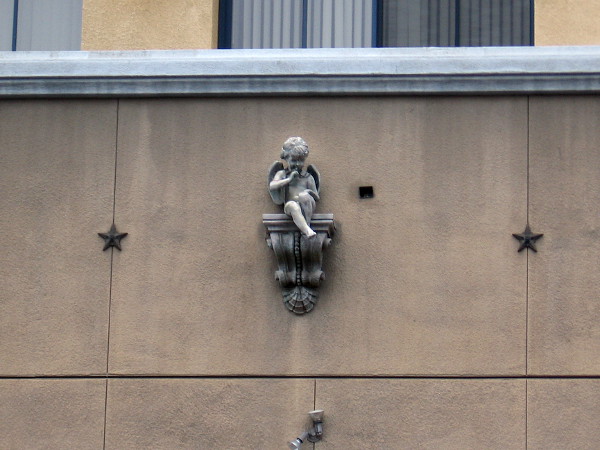 Sculpture of a winged cherub sits above a service entrance to the Horton Plaza shopping mall on Fourth Avenue.