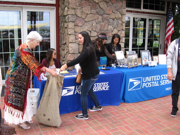 Mail collected at a USPS table is put into a canvas airmail bag. Each piece will be postmarked at the 12 stops along the 1200 mile flight.