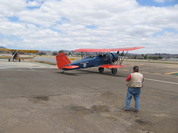 The first Stearman Speedmail biplane taxis out onto the runway.
