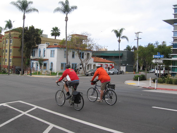 Some guys ride their bikes down Fourth Avenue through Bankers Hill.