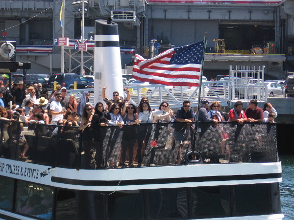 A bunch of happy people on the ferry to Coronado waved at me from beneath the ship's American flag.