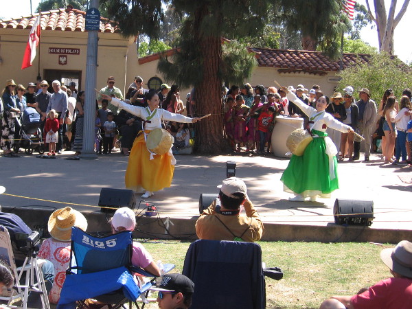 Colorful dancers grace the outdoor stage at the International Cottages.