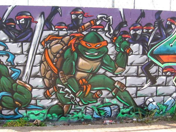 Michelangelo of the Teenage Mutant Ninja Turtles surrounded by enemies.
