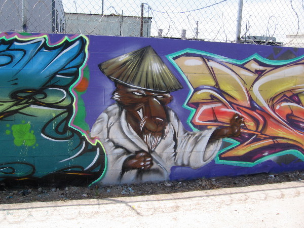 Splinter, the rat sensei, is hanging out between more cool graffiti.