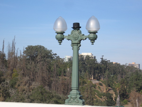A top hat perched oddly atop a lamppost on the Cabrillo Bridge.