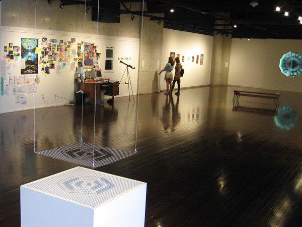Visitors view artwork that concerns space travel and its effect on modern life, culture and human imagination.