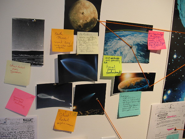 The collage-like artwork pokes gentle fun at the notion the moon landing was a hoax, and that governments conspire to suppress evidence of extraterrestrials.