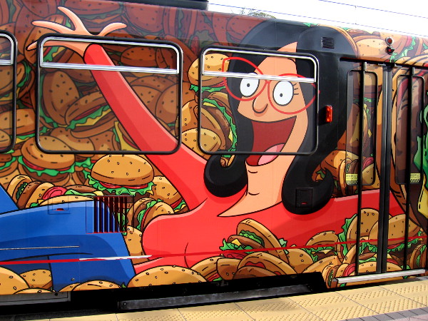 Linda Belcher of Bob's Burgers is having a good time among lots of hamburgers.