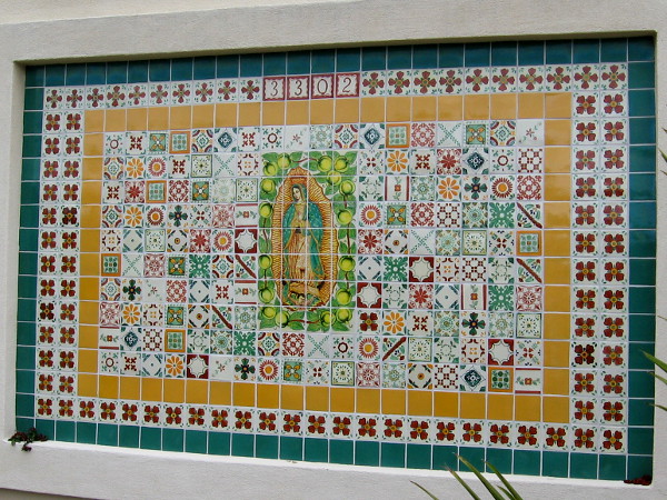 Beautiful tile mosaic with Virgin Mary at its center on a wall in North Park.