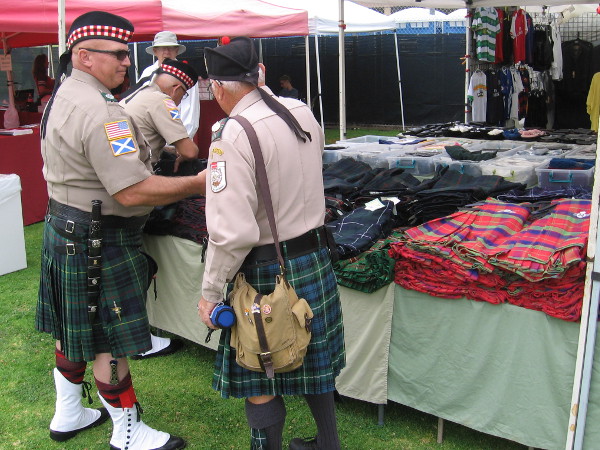 Gentlemen in kilts enjoy their Scottish heritage and each other's company.