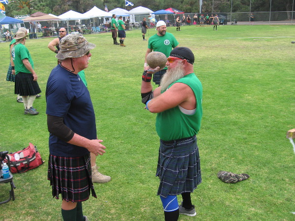 The athletes talk and rest before each takes their turn.