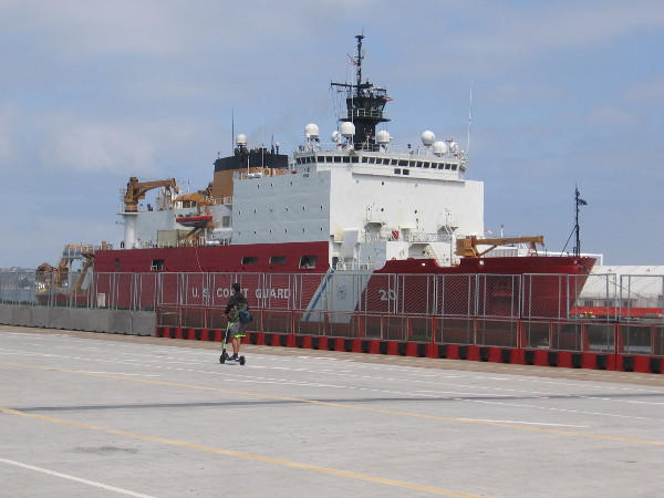 Someone rides a scooter along Broadway Pier past the Coast Guard's newest, most advanced polar icebreaker. I haven't spotted any ice off San Diego!