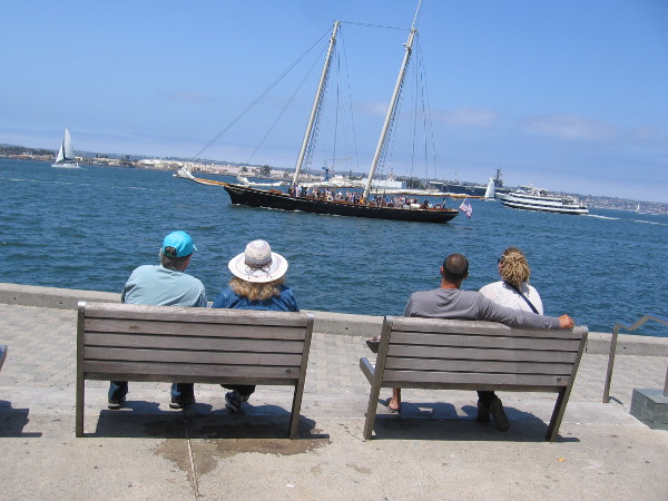 America, replica of the racing yacht that won the first America's Cup, cruises past.