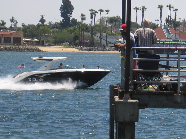 On the water in a boat, and above it on a pier.