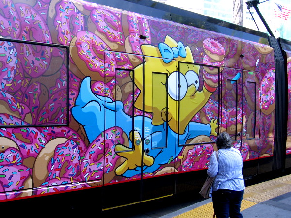 Maggie's pacifier is stacked high with doughnuts.