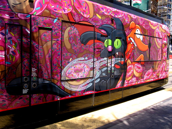 Santa's Little Helper helps Snowball II cough up not a hairball, but a whole donut!