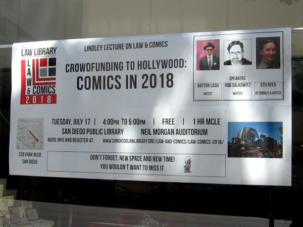 Sign in window of the San Diego Law Library concerns the Lindley Lecture on Law and Comics, which will be held in the Neil Morgan Auditorium of the Central Library during Comic-Con.