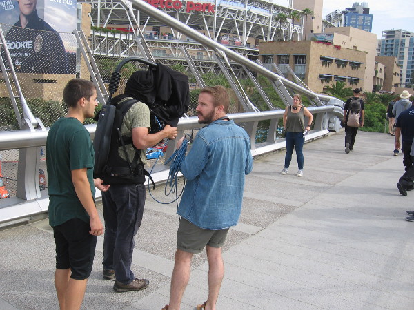 A BBC film crew gets ready to cover 2018 San Diego Comic-Con on the Harbor Drive pedestrian bridge.