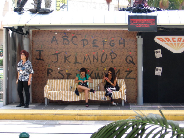 People wait for a Green Line trolley at the Stranger Things station by the convention center.