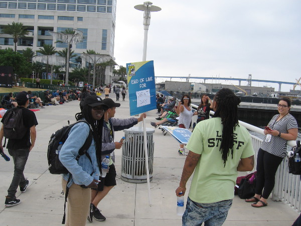 These sign guys have to keep moving as the lines grow longer.