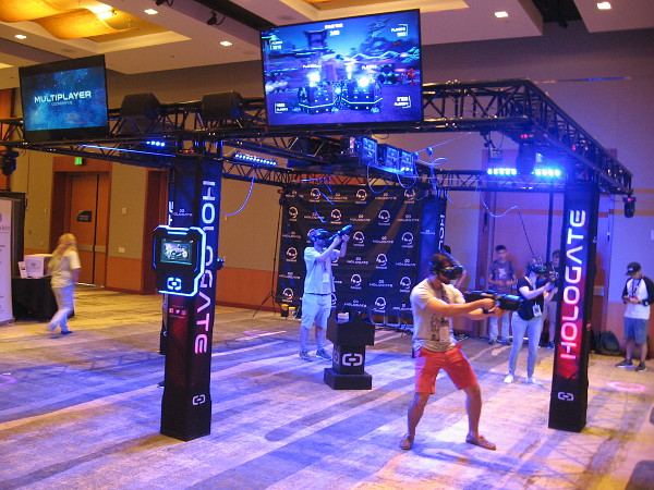 Multiple players enjoy a team gaming experience inside a Hologate virtual reality system.