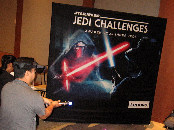 Someone engages in an augmented reality lightsaber battle courtesy of Star Wars Jedi Challenges by Lenovo.