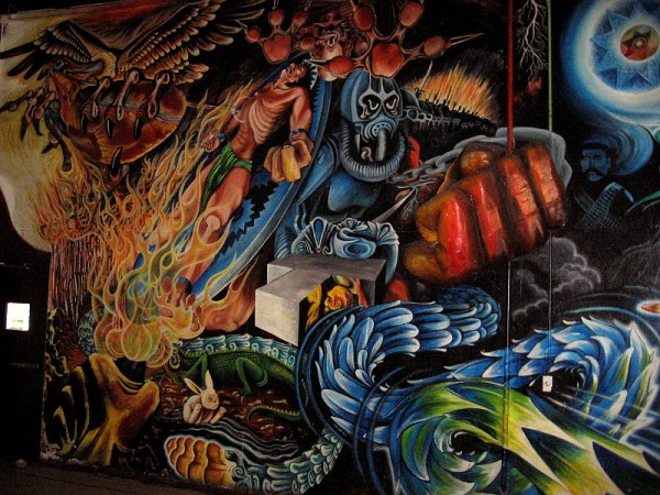 Tezcatlipoca, jaguar, god of night, war and destruction, dominates the dark, violent left section of the large mural inside Centro Cultural de la Raza.