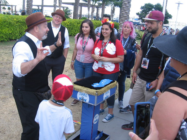 Magicians perform, delighting young and old alike. There's endless magic at Comic-Con!