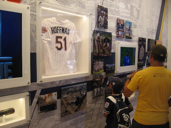 A boy looks up at a Trevor Hoffman jersey in the Padres Hall of Fame.