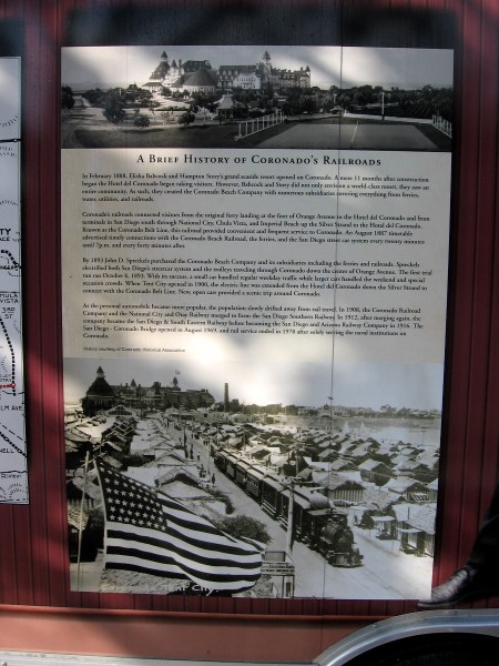 Sign describes the history of Coronado's railroads. John D. Spreckels built a line that went up the Silver Strand, bringing passengers to the Hotel del Coronado and Tent City.