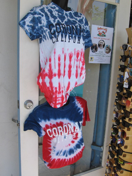 These tie-dye Coronado shirts in front of a shop are red, white and blue.