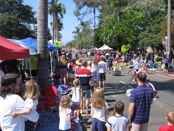 Hats are removed and hands placed over hearts as thousands sing the National Anthem.