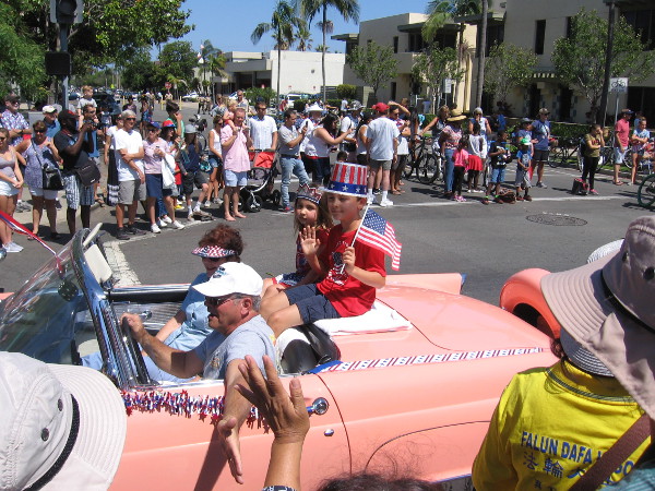 Kids wave to the crowd.