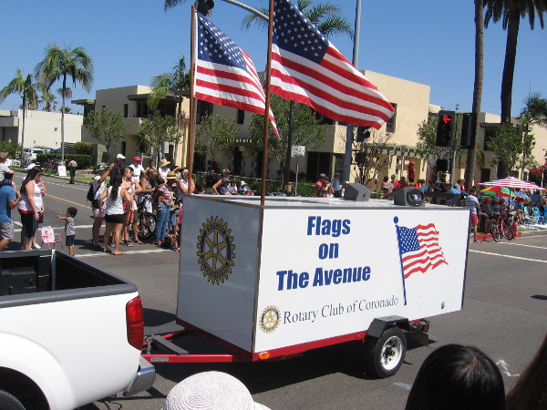 During patriotic holidays, the Rotary Club of Coronado lines Orange Avenue's grassy median with American flags.