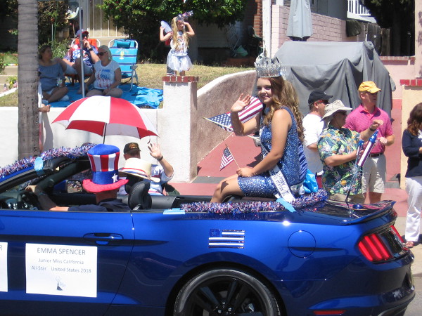 A beauty queen smiles and waves.