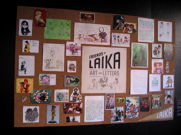 A board contains Laika fan art and letters.